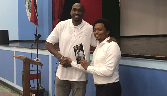 Former pro basketballer Kibwe Trim shows off his book at his alma mater St Mary’s College yesterday.