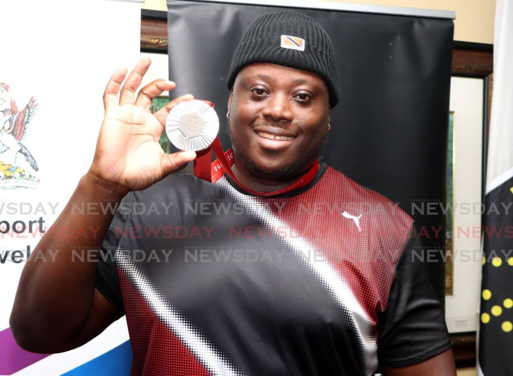 Paralympic Games men’s discuss F64 silver medallist Akeem Stewart shows off his medal after his return to Piarco International Airport, Piarco on September 10. (Image obtained at newsday.co.tt)